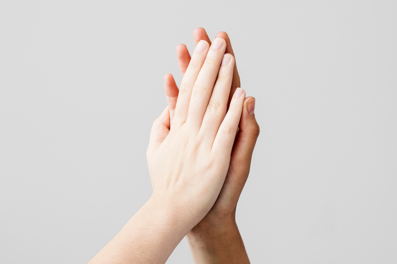 High five gesture on gray background